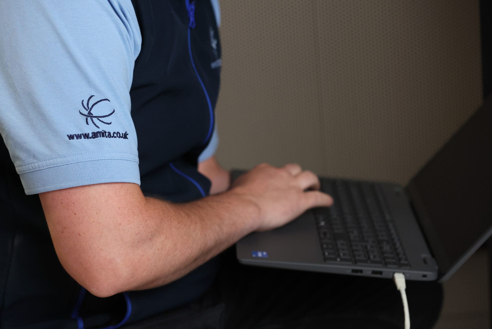 a man holding a laptop on his lap