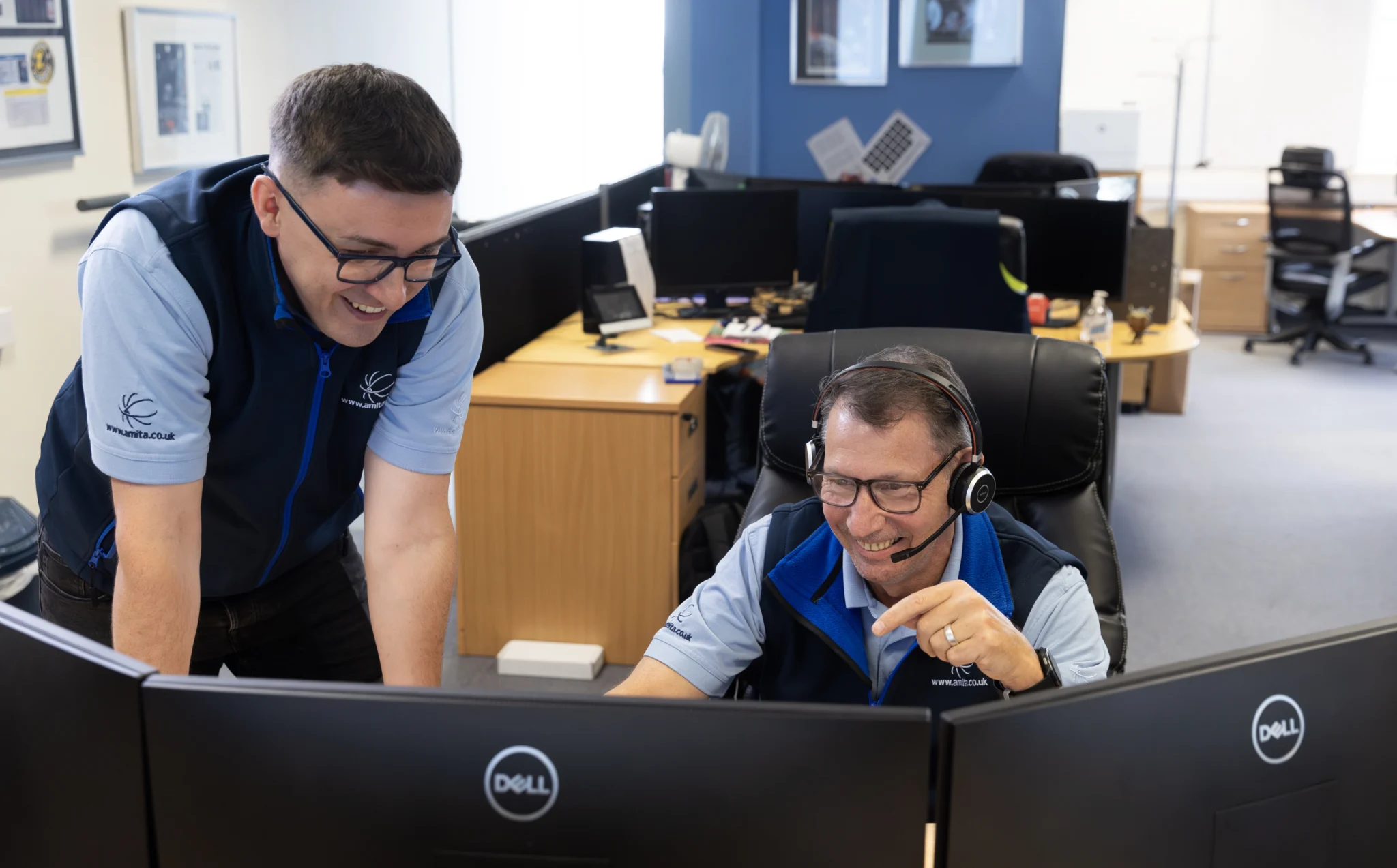two men working together and laughing